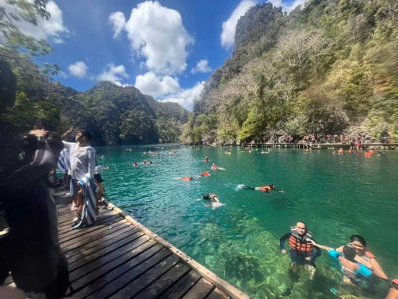 Coron Shared Island Tour A - Green Lagoon: calm water beneath the cliffs