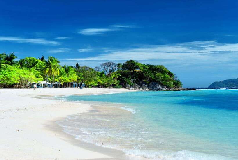 Coron Town: Coron Island Escapade Private Tour with Lunch - Banana Island, a narrow beach beneath forested hills