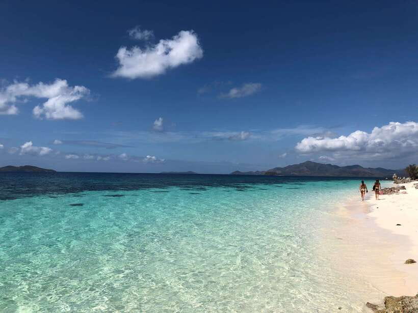From Coron: Private Island-Hopping Cruise with Lunch - Banana Island pairs sand with easy reef viewing